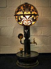 Steampunk Art floor lamp: Decorative piece of art with skulls and flowers.