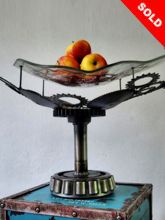 Steampunk Deco fruit bowl: Decorative piece of art made of bicycle gears and melted glass.